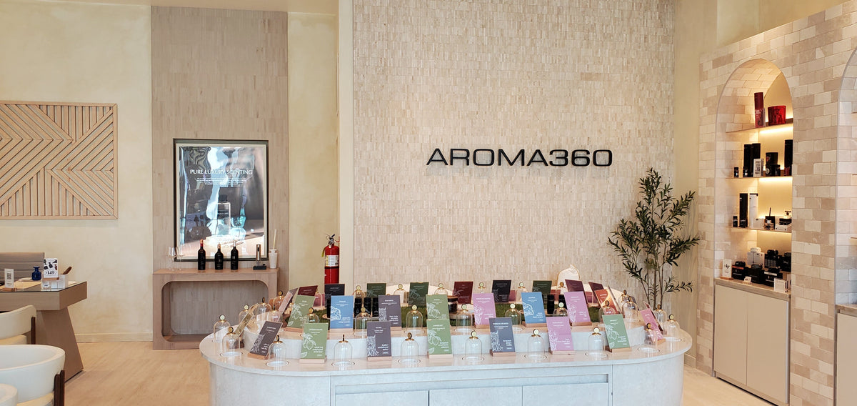 Scent showcase at Aroma360 in Garden City, New York, inside Roosevelt Field® Mall, featuring brochures educating about each fragrance offered.